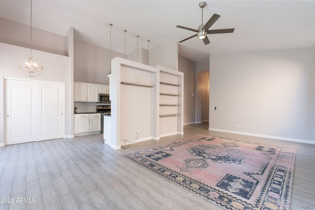 3055 N Red Mtn Unit 122, Mesa, AZ 85207 - unfurnished living room featuring ceiling fan, arched walkways, a chandelier, high vaulted ceiling, and baseboards