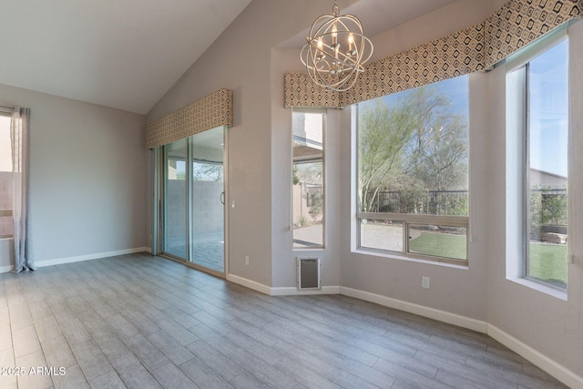 3055 N Red Mtn Unit 122, Mesa, AZ 85207 - spare room with a chandelier, wood finished floors, vaulted ceiling, and baseboards