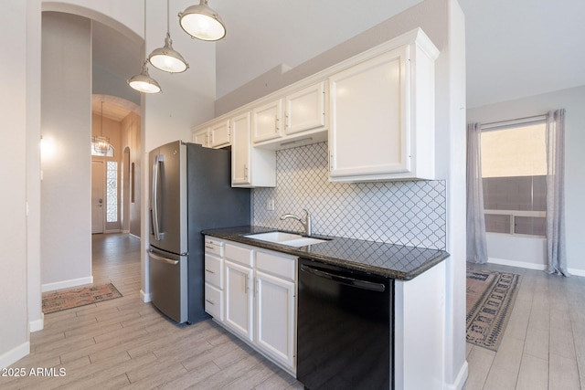 3055 N Red Mtn Unit 122, Mesa, AZ 85207 - kitchen featuring black dishwasher, arched walkways, a sink, white cabinetry, and light wood-style floors