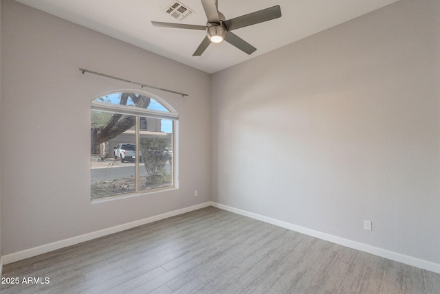 3055 N Red Mtn Unit 122, Mesa, AZ 85207 - spare room featuring wood finished floors, ceiling fan, and baseboards