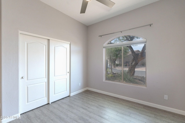 3055 N Red Mtn Unit 122, Mesa, AZ 85207 - unfurnished bedroom featuring wood finished floors, a closet, baseboards, and a ceiling fan
