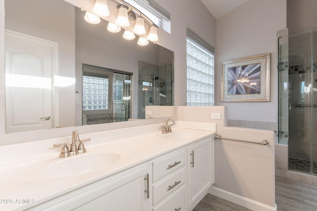 3055 N Red Mtn Unit 122, Mesa, AZ 85207 - bathroom with double vanity, a stall shower, and wood finished floors
