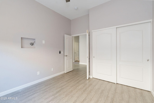 3055 N Red Mtn Unit 122, Mesa, AZ 85207 - unfurnished bedroom with light wood-style flooring, baseboards, and a closet
