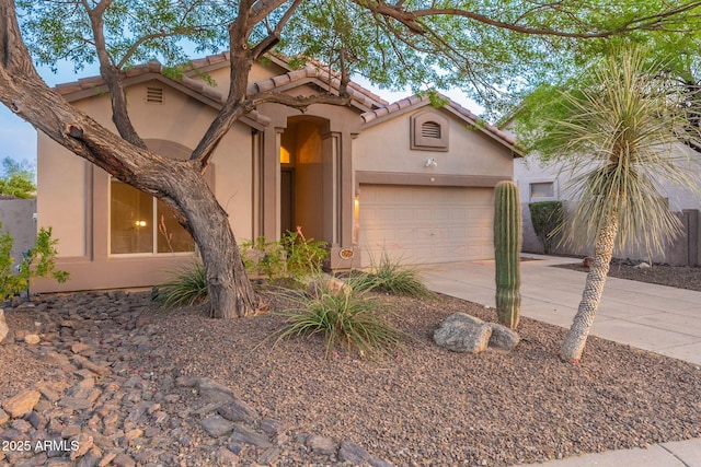 3055 N Red Mtn Unit 122, Mesa, AZ 85207 - mediterranean / spanish home with stucco siding, driveway, an attached garage, and a tiled roof