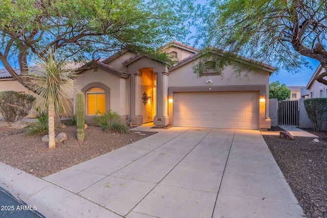 3055 N Red Mtn Unit 122, Mesa, AZ 85207 - mediterranean / spanish-style home with stucco siding, driveway, a garage, a gate, and a tiled roof