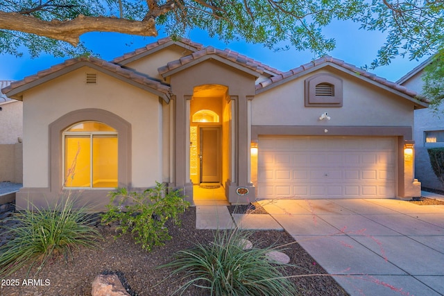 3055 N Red Mtn Unit 122, Mesa, AZ 85207 - mediterranean / spanish-style house with stucco siding, driveway, a garage, and a tile roof