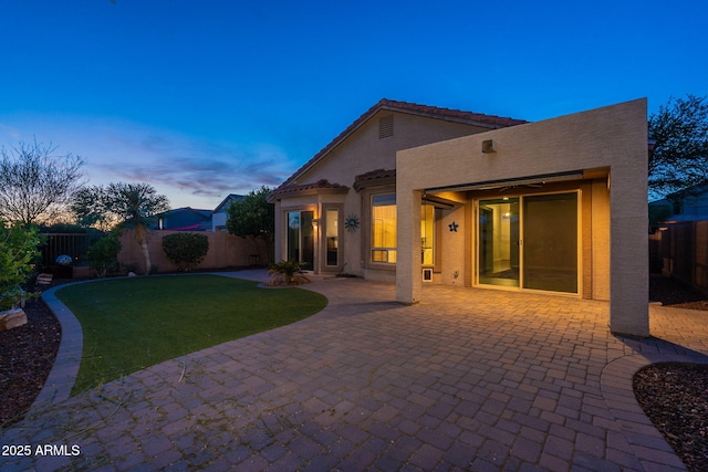 3055 N Red Mtn Unit 122, Mesa, AZ 85207 - back of house at dusk featuring stucco siding and a patio