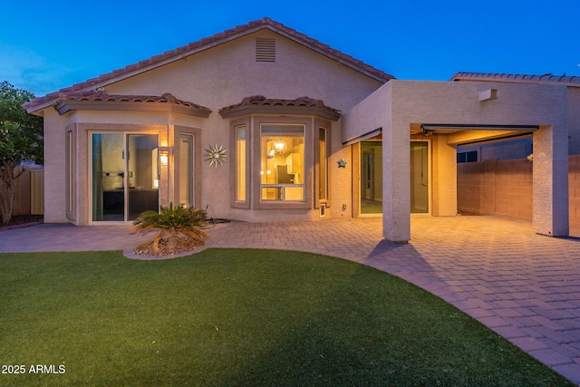 3055 N Red Mtn Unit 122, Mesa, AZ 85207 - rear view of house with a patio, stucco siding, and a tiled roof