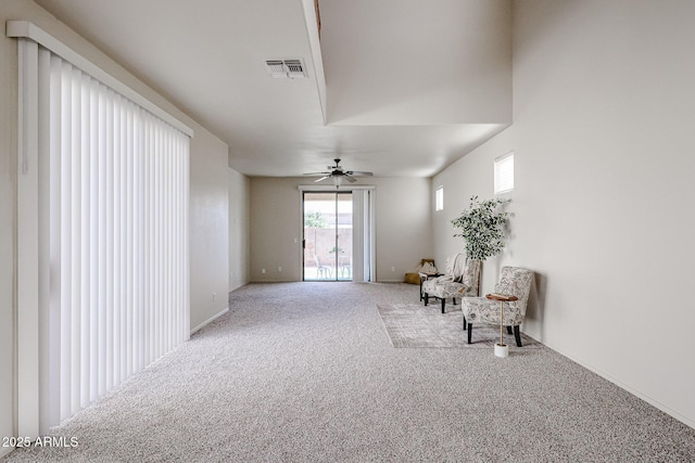 unfurnished room with baseboards, a ceiling fan, visible vents, and carpet floors