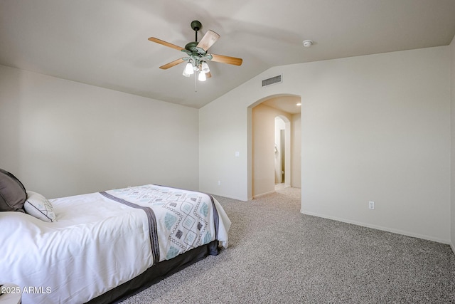 bedroom with vaulted ceiling, a ceiling fan, arched walkways, carpet, and visible vents