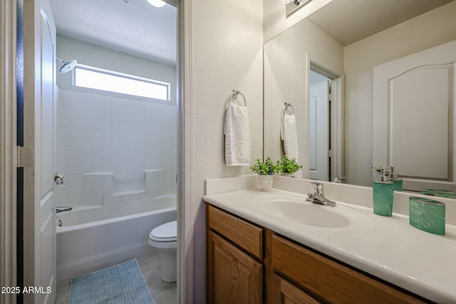 bathroom featuring tile patterned flooring, tub / shower combination, toilet, and vanity