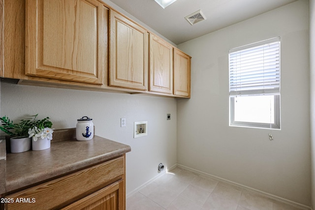 laundry area featuring electric dryer hookup, visible vents, a wealth of natural light, and cabinet space