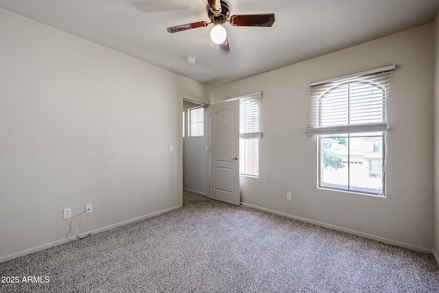 unfurnished room featuring carpet, baseboards, and ceiling fan