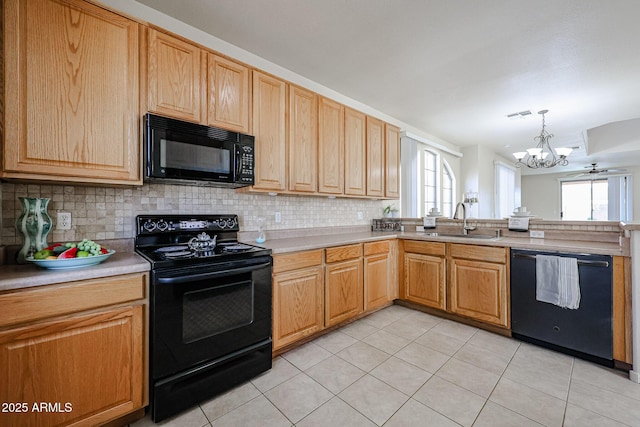 kitchen featuring backsplash, a notable chandelier, a sink, and black appliances
