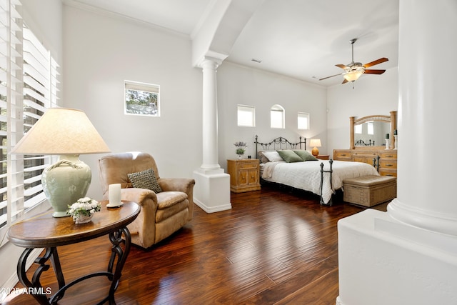 bedroom featuring ornate columns, crown molding, dark hardwood / wood-style floors, and ceiling fan