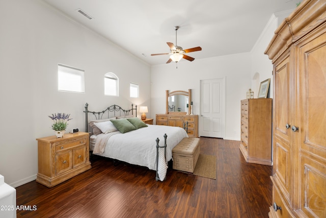 bedroom featuring crown molding, dark hardwood / wood-style floors, and ceiling fan