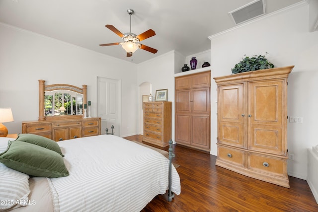 bedroom featuring crown molding, dark hardwood / wood-style floors, and ceiling fan