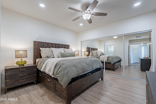 bedroom featuring ceiling fan, a closet, and light hardwood / wood-style flooring