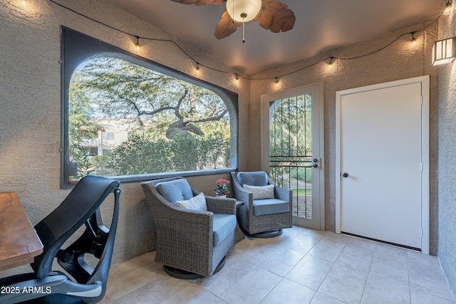 sunroom / solarium featuring ceiling fan