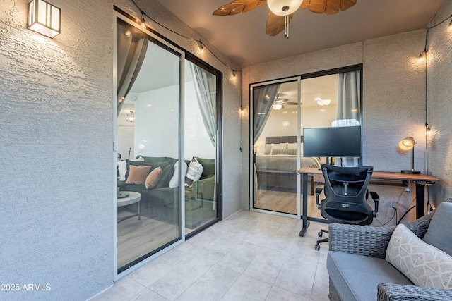 office space featuring ceiling fan and light tile patterned floors