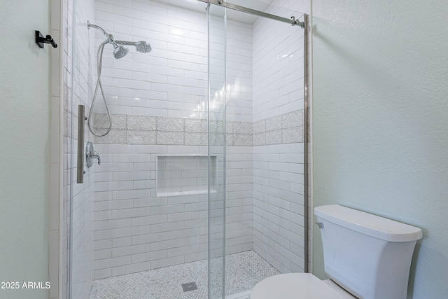 bathroom featuring toilet and an enclosed shower