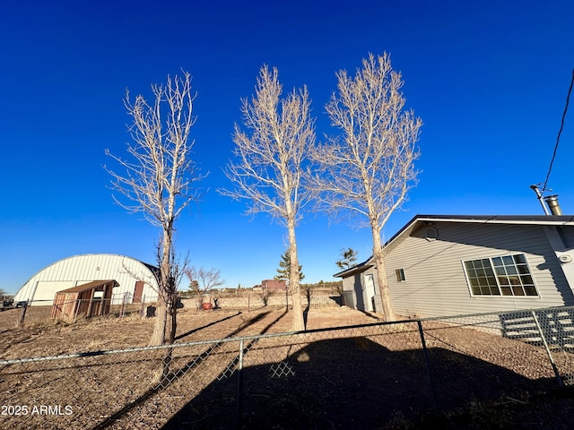 view of yard with an outbuilding and fence