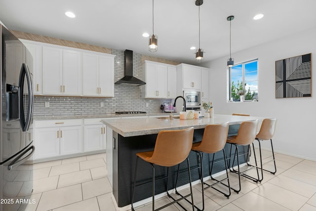 22501 E Indiana Ave, Queen Creek, AZ 85142 - kitchen with appliances with stainless steel finishes, sink, wall chimney range hood, white cabinets, and a kitchen island with sink