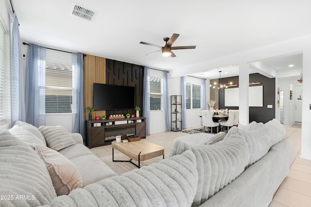22501 E Indiana Ave, Queen Creek, AZ 85142 - tiled living room with a wealth of natural light and ceiling fan with notable chandelier