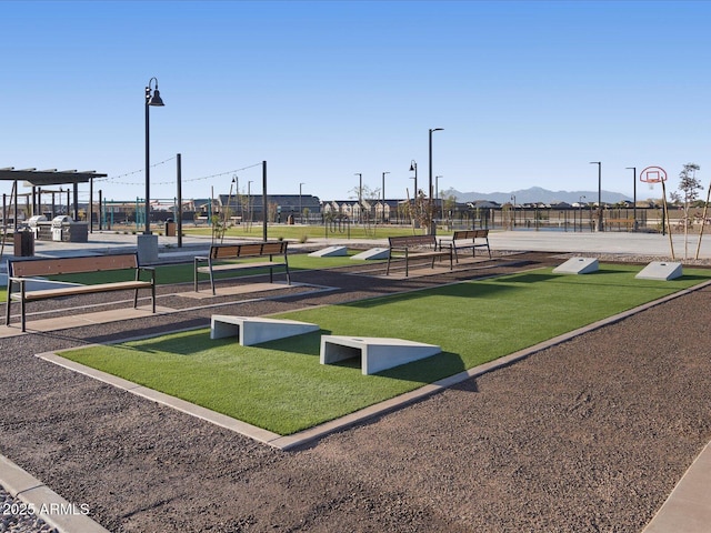 view of property's community featuring basketball hoop