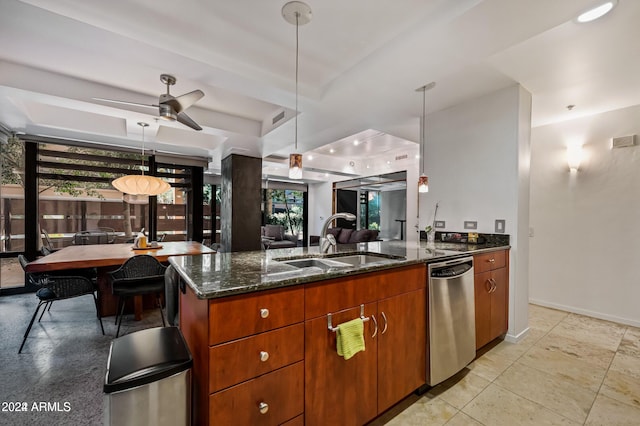 kitchen with pendant lighting, a tray ceiling, stainless steel dishwasher, and ceiling fan