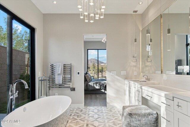 bathroom featuring vanity, a mountain view, hardwood / wood-style flooring, and a bathing tub