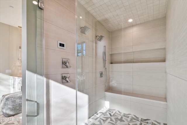 bathroom featuring an enclosed shower and tile patterned floors