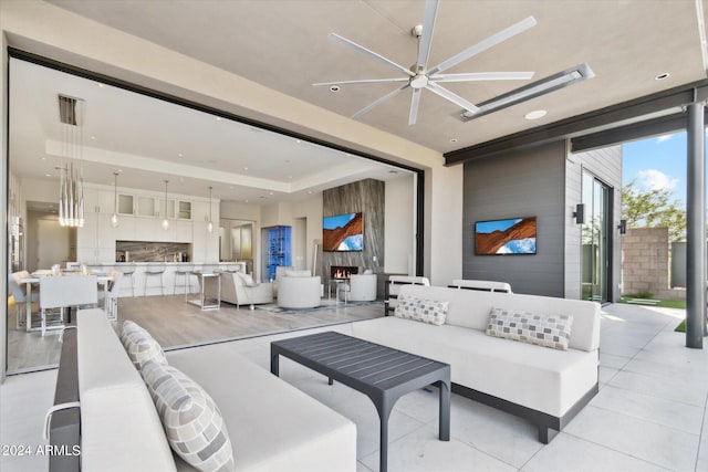 view of patio / terrace with an outdoor living space and ceiling fan