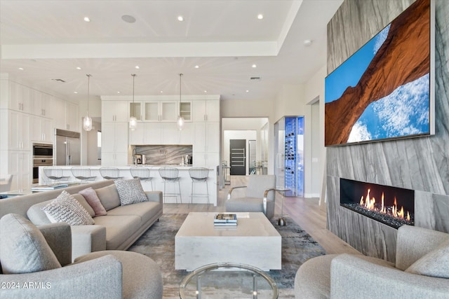 living room with a fireplace and light wood-type flooring