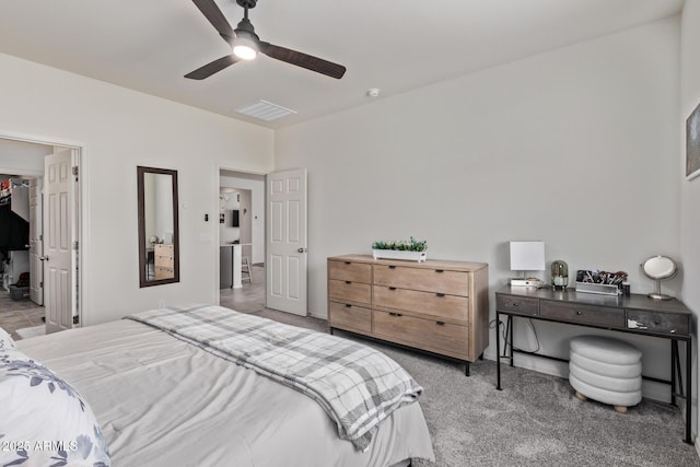 bedroom with a ceiling fan, carpet, and a spacious closet