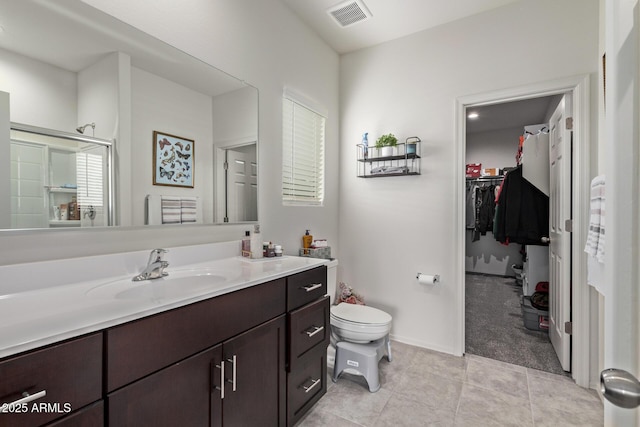 bathroom with visible vents, toilet, tile patterned flooring, baseboards, and vanity