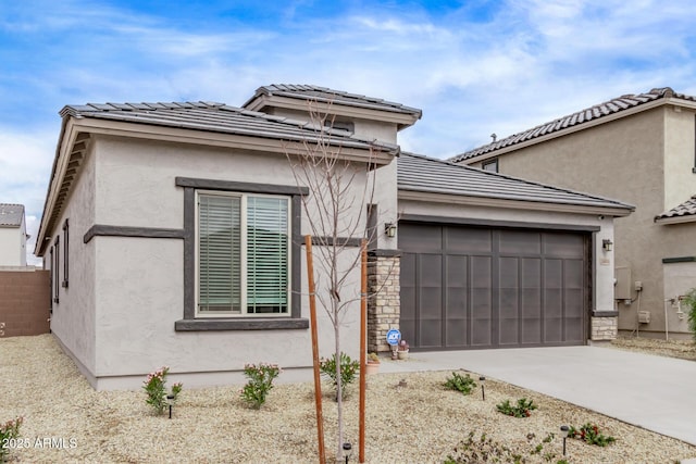 view of front of property with a garage, concrete driveway, and stucco siding