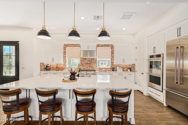 kitchen with a center island, white cabinets, and appliances with stainless steel finishes