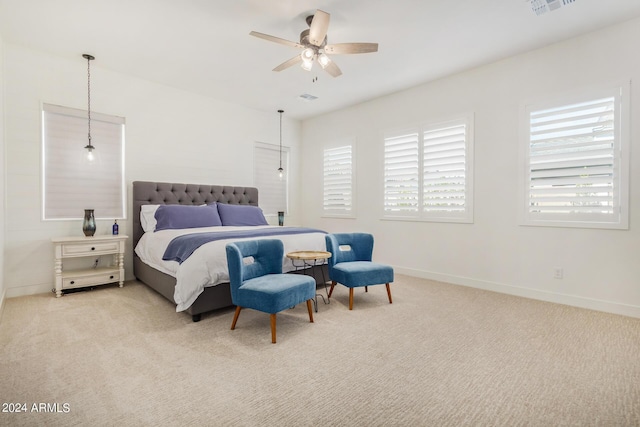 bedroom featuring light colored carpet and ceiling fan