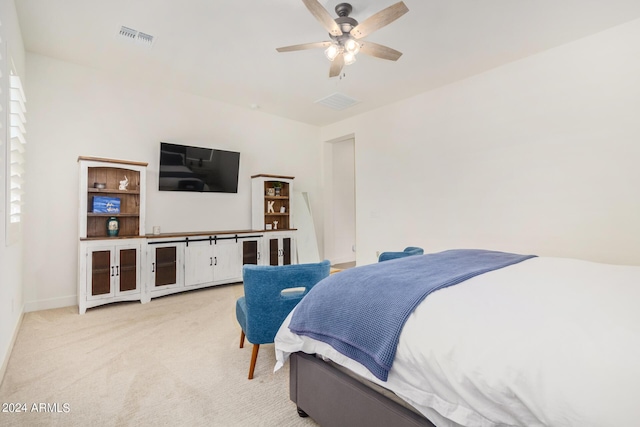 bedroom with ceiling fan and light carpet