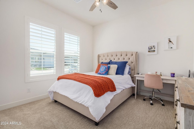 carpeted bedroom featuring ceiling fan and multiple windows