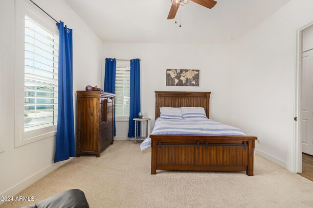 bedroom featuring ceiling fan and light colored carpet