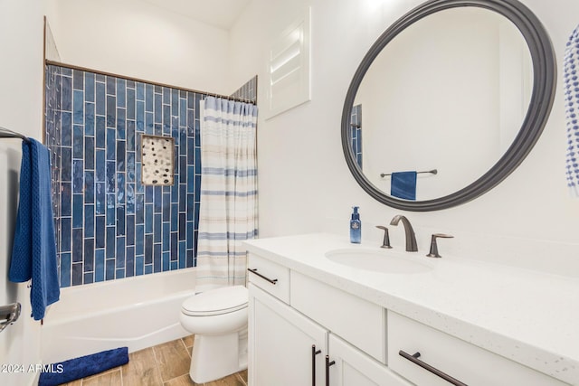 full bathroom with shower / bath combo, hardwood / wood-style floors, vanity, and toilet