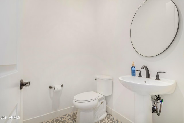 bathroom featuring tile patterned flooring and toilet