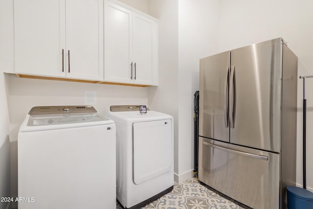 laundry area featuring cabinets and separate washer and dryer