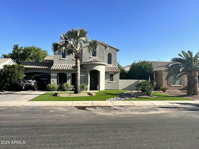 mediterranean / spanish home featuring a front yard