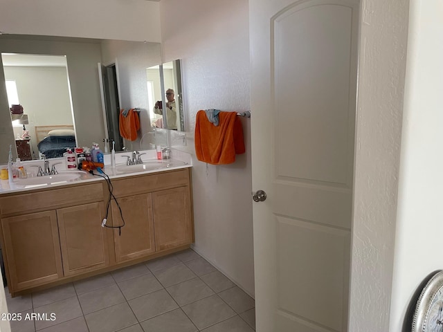 bathroom with tile patterned flooring and vanity