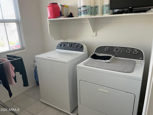 clothes washing area featuring light tile patterned flooring and independent washer and dryer