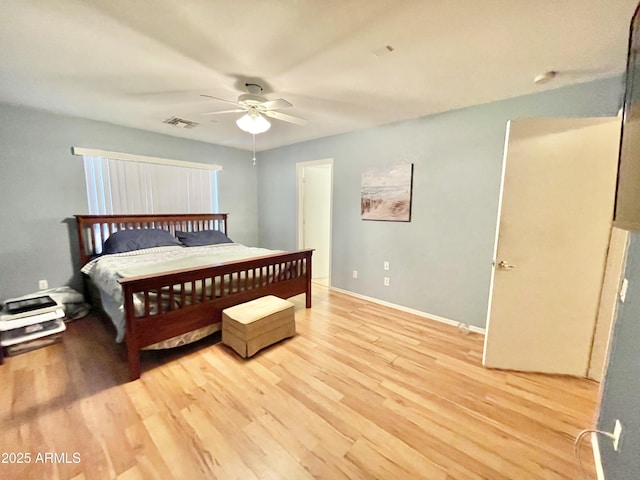 bedroom with light wood-style floors, baseboards, and ceiling fan