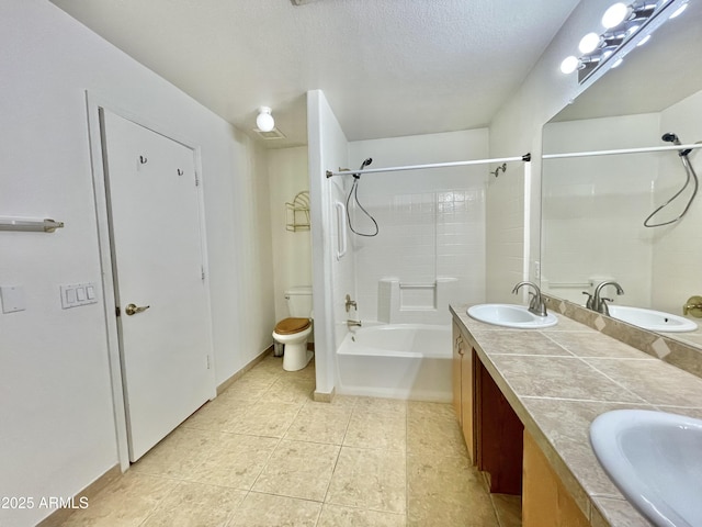 bathroom with tile patterned floors, double vanity, toilet, a textured ceiling, and washtub / shower combination